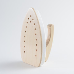 Wooden toy iron on white background