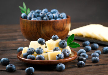 blueberries with cheese on a wooden background