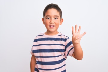 Beautiful kid boy wearing casual striped t-shirt standing over isolated white background showing and pointing up with fingers number four while smiling confident and happy.
