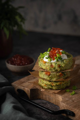 vegetable cutlets are stacked on a wooden board, close-up