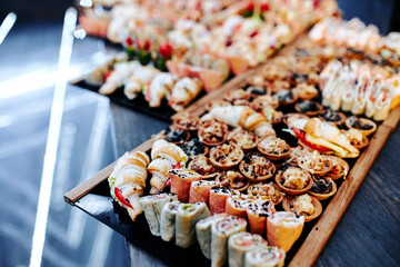 party table with appetizers of vegetables, meat and seafood