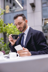 Concentrated brunette male person reading income message