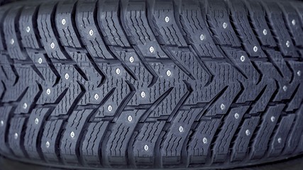 Fototapeta premium Winter tires for the car. Radial tread, thin lamellas and metal spikes.