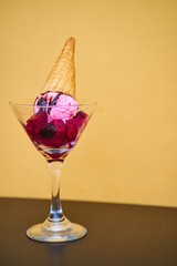 A glass of fruit cocktail with ice cream