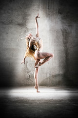 Incredibly beautiful pose of a dancer with flour. Beautiful girl ballerina with blond hair. Dance, emotion, pose, feet, ballet, modern, contemporary, theater, fitness figure, balance, body aesthetics - obrazy, fototapety, plakaty
