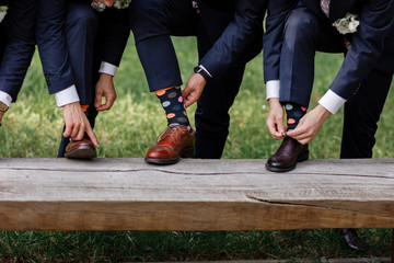 stylish men's socks. Stylish suitcase, men's legs, multicolored socks and new shoes. Concept of...