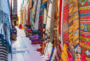 Moroccan carpets with traditional ornaments for sale in the street of Essaouira, Morocco