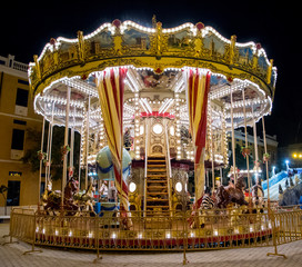 classic carousel illuminated at night at the fair