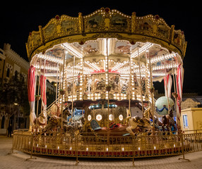 classic carousel illuminated at night at the fair