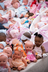 Fototapeta premium Collection of toy dolls at a street market