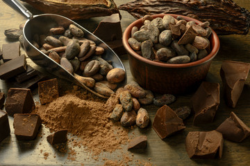 open cocoa fruit lies on a wooden table with cocoa beans
