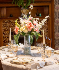 Quaint pink Flowers on traditionally set table