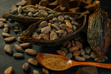 open cocoa fruit lies on a wooden table with cocoa beans