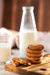 Oatmeal Cookies On A Wooden Board On A Sunny Day With A Glass And A Bottle Of Milk.