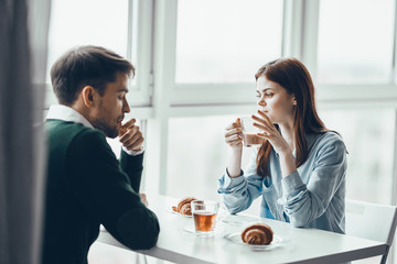 young couple having breakfast in cafe