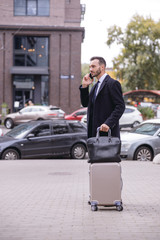 Concentrated bearded man having serious telephone talk
