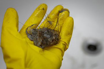 cleaning dirt and hair near drain hole