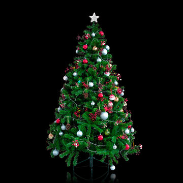 Beautiful Christmas Tree, full length image, decorated with ornament, balls and small lightings, the silver star on top, isolated on black background with clipping Path