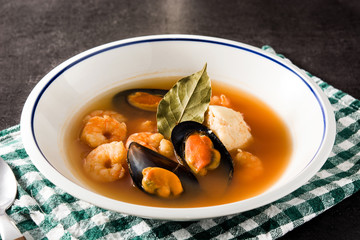 French bouillabaisse soup in white plate	