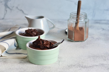 Chocolate fondant with cream on a concrete background.