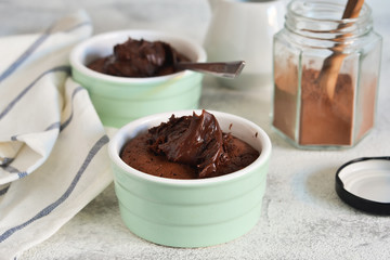 Chocolate fondant with cream on a concrete background.