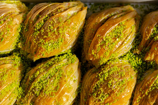 Turkish Midye Baklava ( Mussel Shaped Baklava ) with Green Pistachio Powder and Butter Cream.