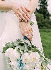 Obraz na płótnie Canvas bride white wedding dress flowers hands conceptual