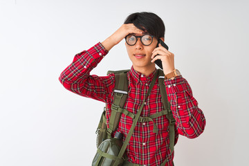 Chinese hiker man wearing canteen talking on smartphone over isolated white background stressed with hand on head, shocked with shame and surprise face, angry and frustrated. Fear and upset 