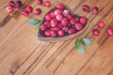 ripe fresh cranberries in a wooden bowl closeup. background with fresh cranberries.
