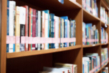 Abstract blurred background close up bookshelf in library, education and knowledge concept.
