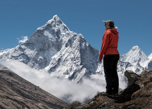 Woman looking ath Nuptse mountain, Himalayas, Solo Khumbu, Nepal
