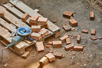 Construction side with bricks being cat with angle grinder
