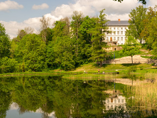 Obraz premium landscape with old castle in the background and blurred flower foreground, Gaujiena, Latvia