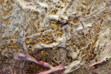 Icing on an ancient gold surface. Multi-layer painting. Сracked paint. Surface of Church utensils