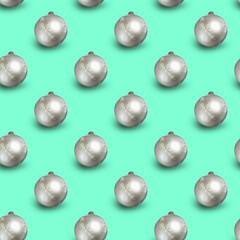 Seamless Christmas pattern with shiny silver balls on mint background.