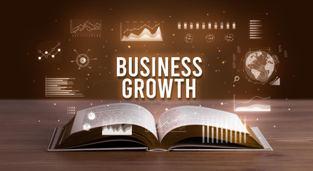 BUSINESS GROWTH inscription coming out from an open book, creative business concept
