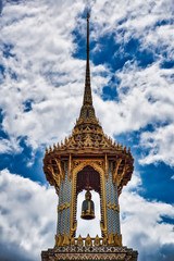 A Thai traditional bell tower (belfry) with detailed, mosaic artwork and gold colored design at Wat Phra Kaew (Temple of the Emerald Buddha) within the precincts of the Grand Palace of Bangkok
