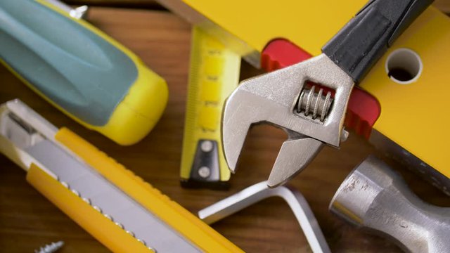 repair, building and carpentry concept - different work tools on wooden boards