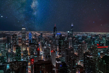 An aerial view of Chicago, Illinois at night time under a starlit sky. © S Quintans