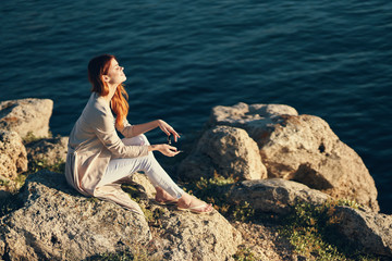 woman sitting on a rock