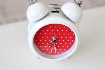 White clock with red dotted background