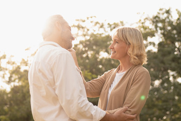 Fototapeta premium Portrait of senior caucasian couple holding each other feeling loved and happy in the afternoon sun, elderly couple anniversary, elderly togetherness, happy retirement,romantic couple, love expression