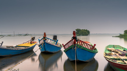 Fototapeta na wymiar Shot of Fishing boats parked near still lake of Bhigwan, Maharashtra