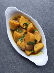 Homemade Indian Taro root  curry or Yam curry on a wooden moody background