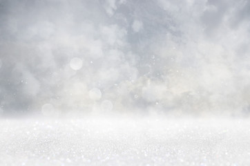 abstract background of glitter vintage lights . silver, gold and white. de-focused