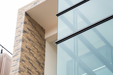 Windows of modern apartment buildings exteriors in cloudy day.