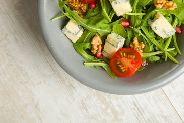 Fresh salad with tomatoes , blue cheese and nuts