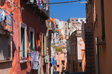 Panoramic view of beautiful Procida on a sunny summer day. Colorful cafes, houses and restaurants, fishing boats and yachts, clear blue sky and the azure sea on the island of Procida, Italy. Napoli