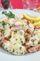 Octopus pieces cooked with garlic and parsley on a plate