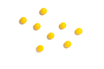 round yellow pills on a white isolated background